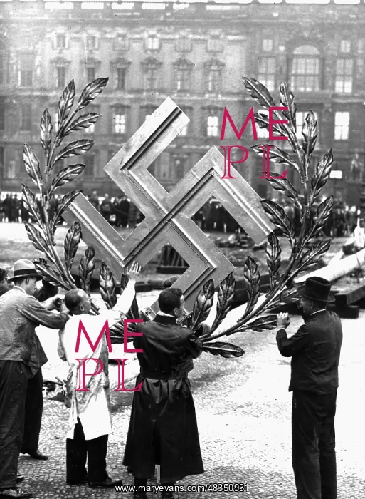 : Workers mounting swastika on a maypole in Berlin : Workers mounting swastika on a maypole in Berlin