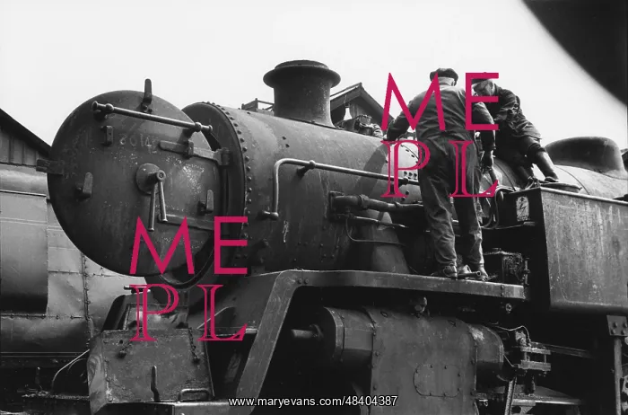 : Two workers on steam engine at Nine Elms Loco Yard : Two workers on steam engine at Nine Elms Loco Yard