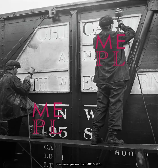  : Workers stenciling the name of the railroad