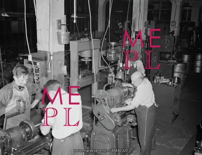 : Workers using lathes in the tool room of the : Workers using lathes in the tool room of the