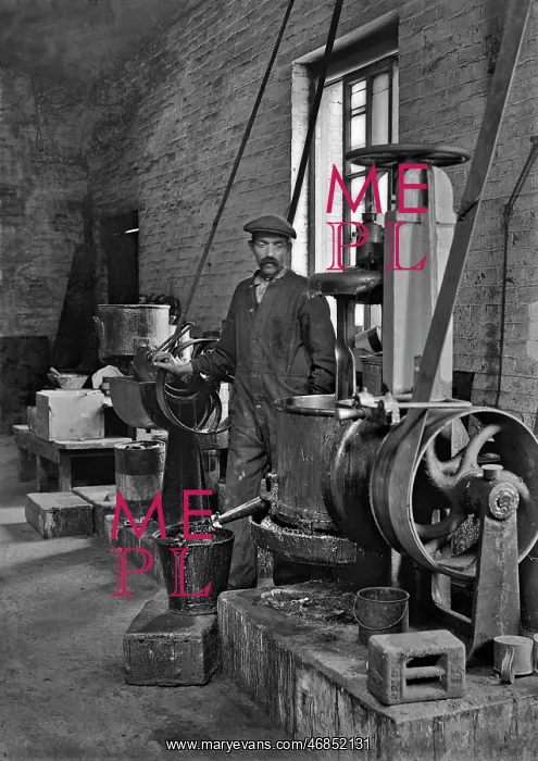 : Workman in a factory operating machinery - lead works : Workman in a factory operating machinery - lead works