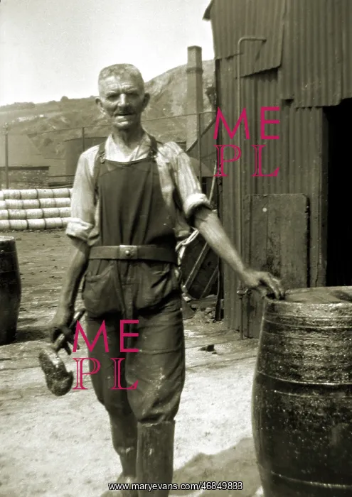 : Workman in overalls with barrel : Workman in overalls with barrel