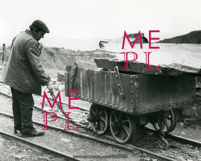 : Workman with slate quarry tram, North Wales : Workman with slate quarry tram, North Wales