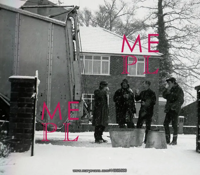 : Four workmen stop for a cup of tea on a snowy day : Four workmen stop for a cup of tea on a snowy day