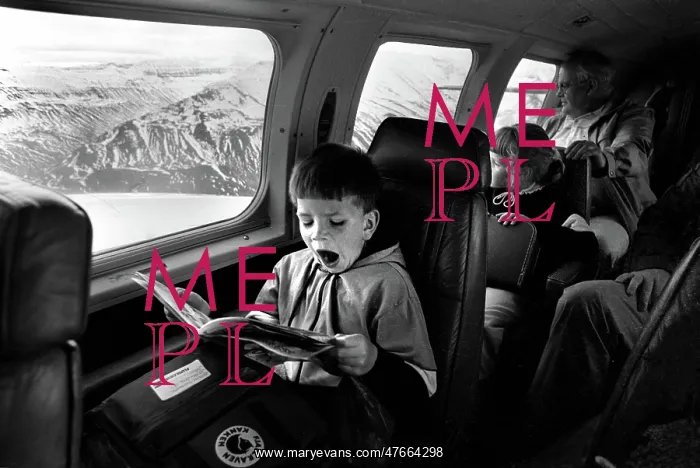  : Yawning boy reads comic during an internal flight in Iceland
