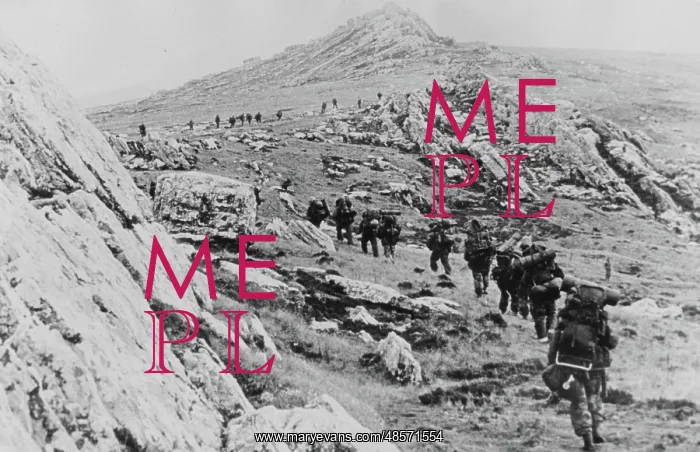 : Yomping. Photograph: Yomping. A line of British troops winding up a rocky hillside : Yomping. Photograph: Yomping. A line of British troops winding up a rocky hillside