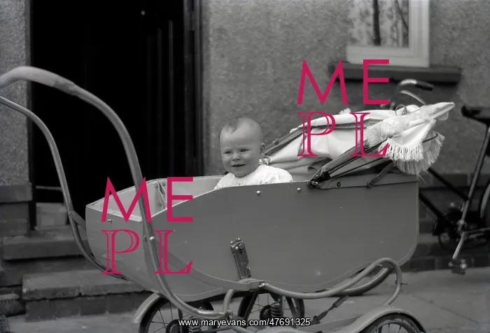 : A young baby in a fine perambulator : A young baby in a fine perambulator