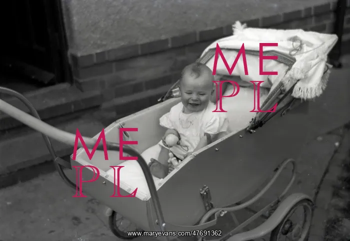  : A young baby in a fine pram