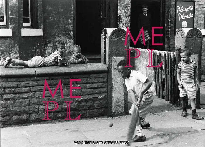 : Young black boys play cricket on the pavement : Young black boys play cricket on the pavement