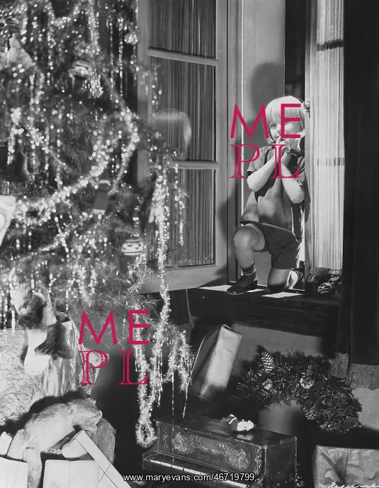 : Young boy admiring Christmas tree and presents from window : Young boy admiring Christmas tree and presents from window