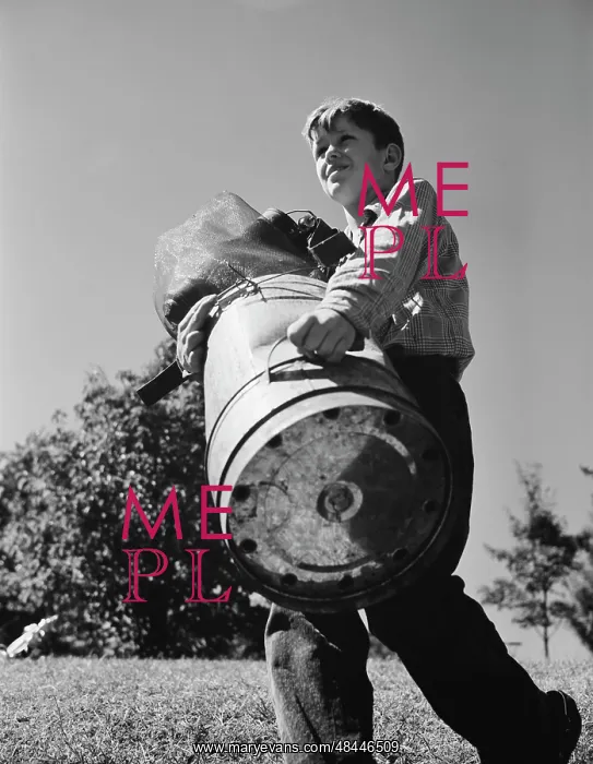  : A young boy collects scrap for America's war