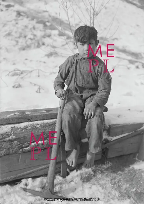 : A young boy digging coal from mine refuse : A young boy digging coal from mine refuse