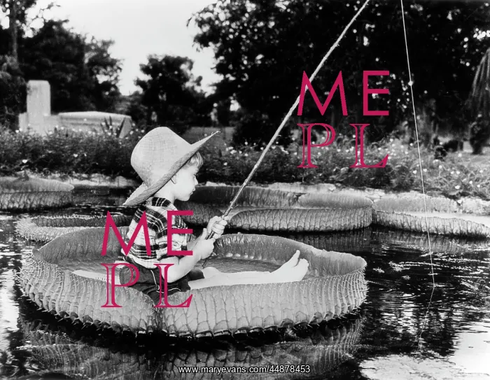  : Young Boy Floating On Lilly Pad