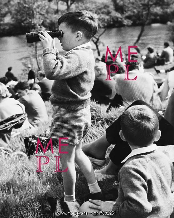 : Young boy looking through binoculars - Chester, 1961 : Young boy looking through binoculars - Chester, 1961