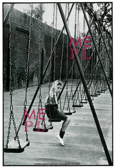 : Young boy alone on a playground swing 1939 : Young boy alone on a playground swing 1939