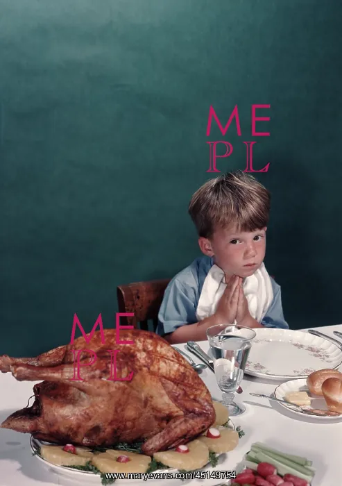 : Young boy sitting at dinner table eyeing turkey : Young boy sitting at dinner table eyeing turkey