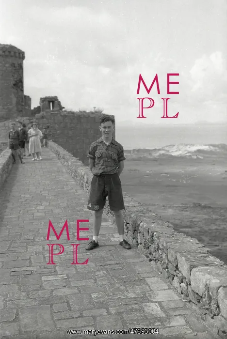 : Young boy standing on the ramparts of Harlech Castle : Young boy standing on the ramparts of Harlech Castle