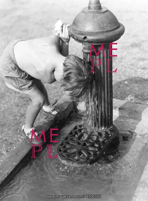 : Young child with head under hydrant : Young child with head under hydrant