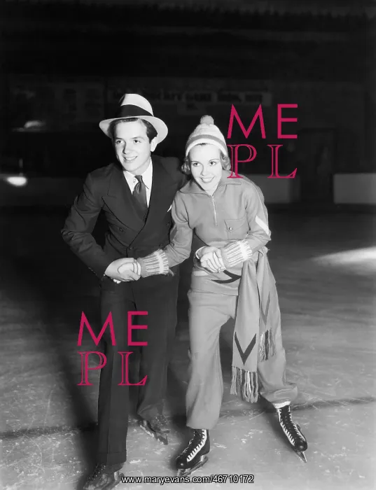 : Young couple ice skating together : Young couple ice skating together