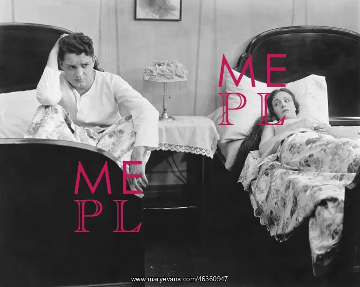 : Young couple in separate beds after fight : Young couple in separate beds after fight
