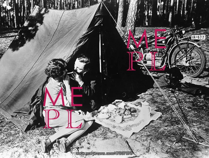 : Young couple in front of a tent : Young couple in front of a tent