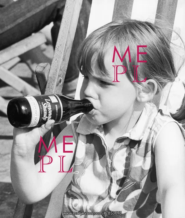  : Young girl drinking bottle of lemonade shandy