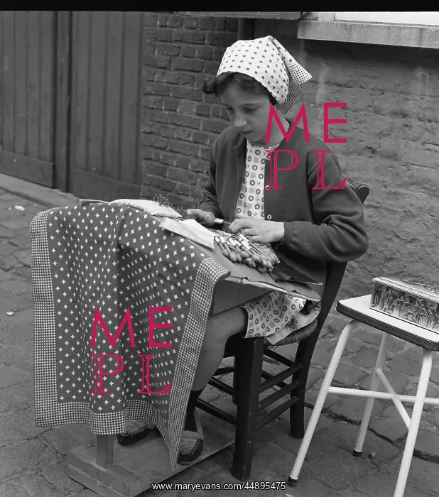: Young girl making lace on the pavement : Young girl making lace on the pavement
