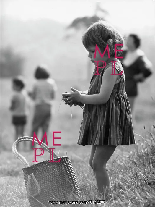 : Young girl in a park with grass in her hands : Young girl in a park with grass in her hands