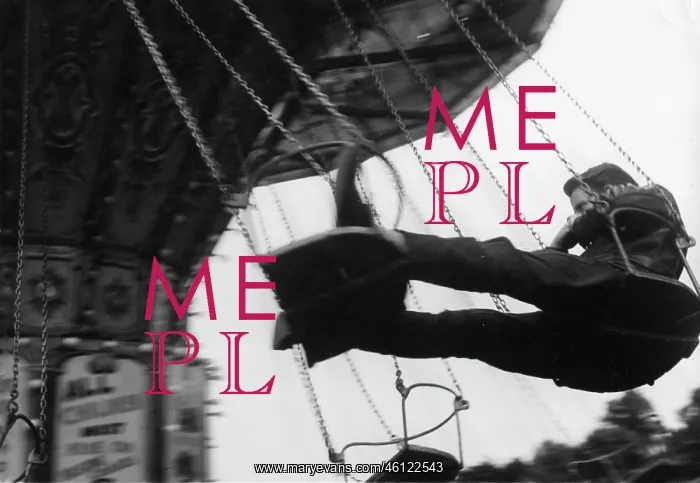 : Young man on chain swing fairground ride : Young man on chain swing fairground ride