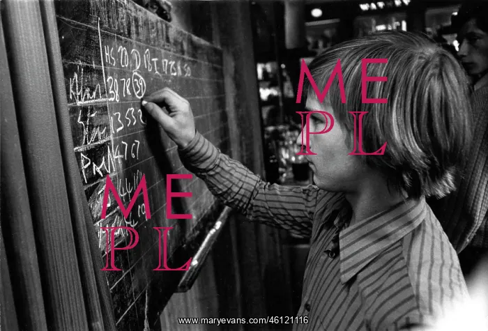 : Young man chalking up darts scores in a pub : Young man chalking up darts scores in a pub