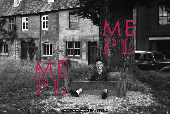 : Young man fooling about in The Stocks : Young man fooling about in The Stocks