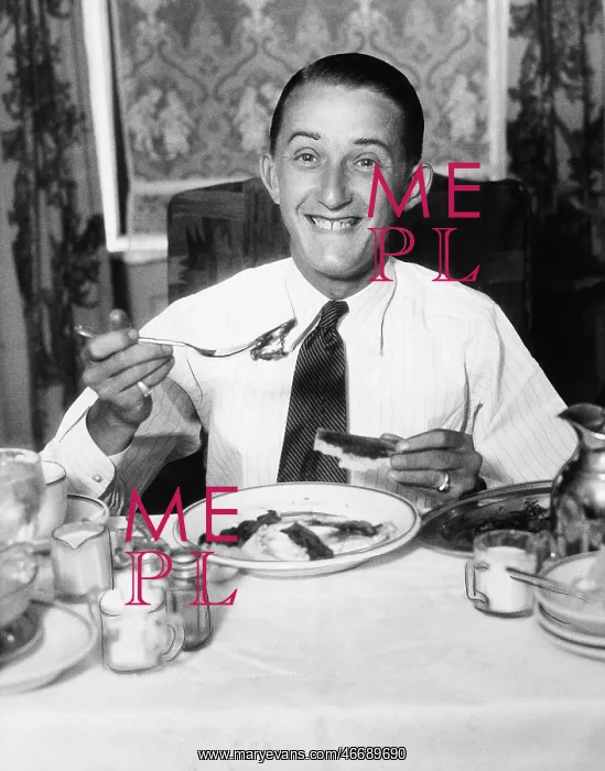 : Young man having breakfast and smiling : Young man having breakfast and smiling