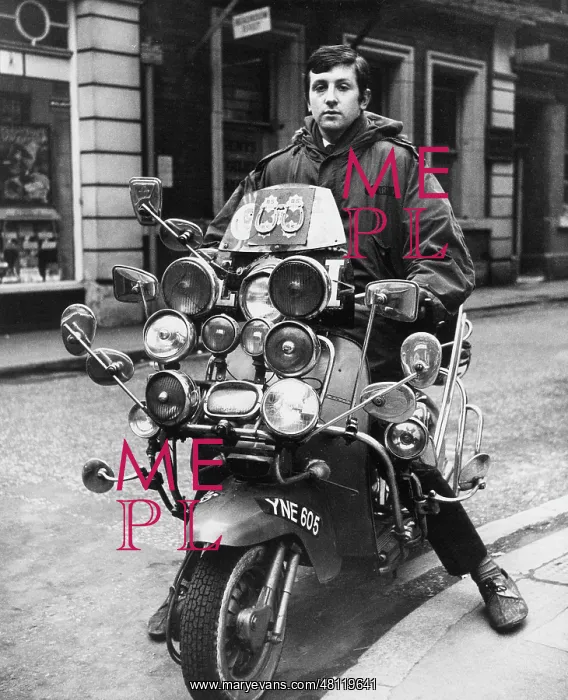: Young man on a motor scooter : Young man on a motor scooter