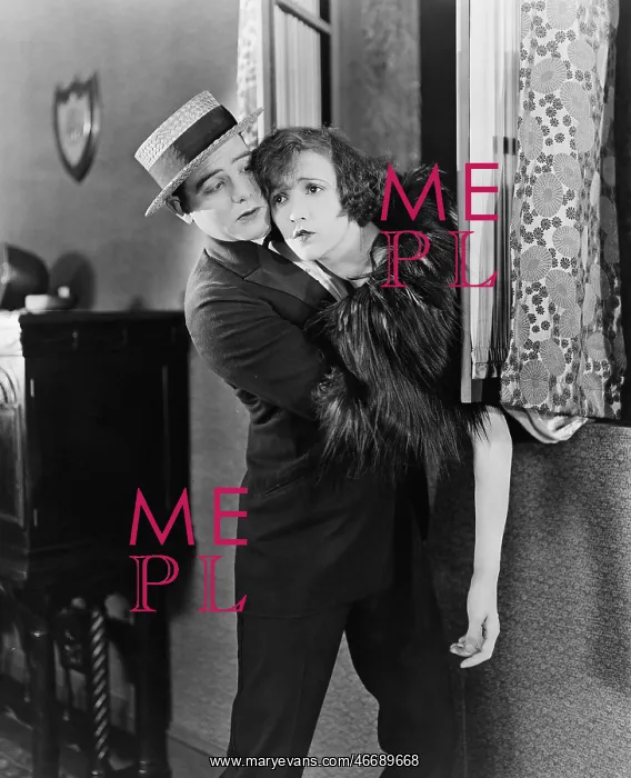 : Young man pulling a young woman from a window : Young man pulling a young woman from a window