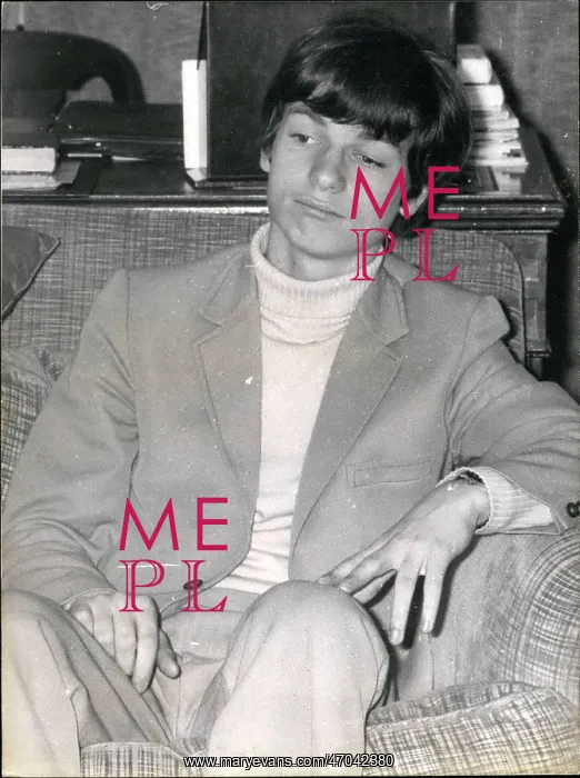 : Young man sitting in an armchair : Young man sitting in an armchair