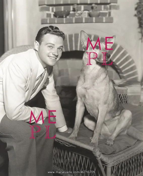  : Young man sitting with dog at home