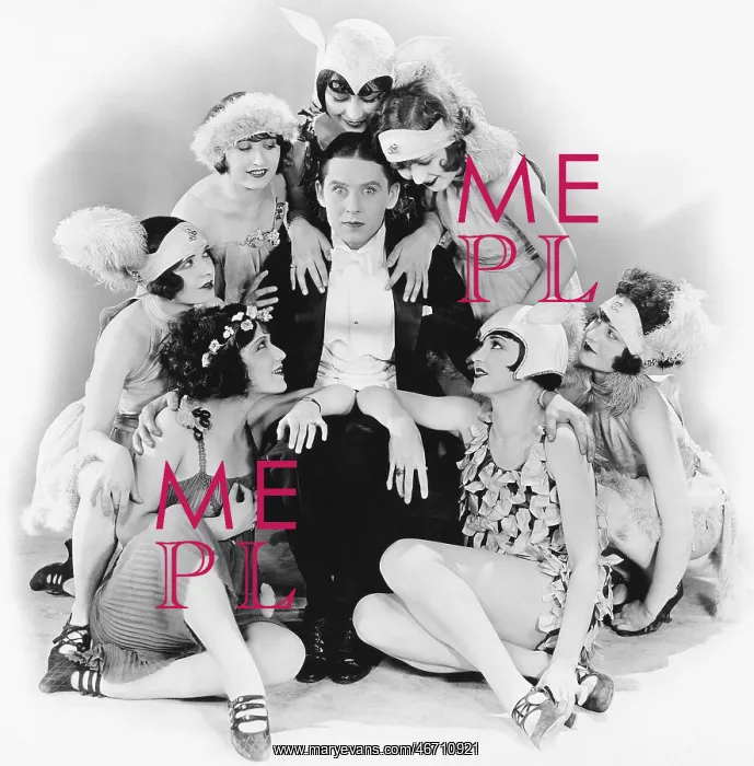 : Young man sitting with a group of young women around him : Young man sitting with a group of young women around him