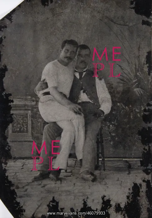 : Young man sitting on the lap of a : Young man sitting on the lap of a