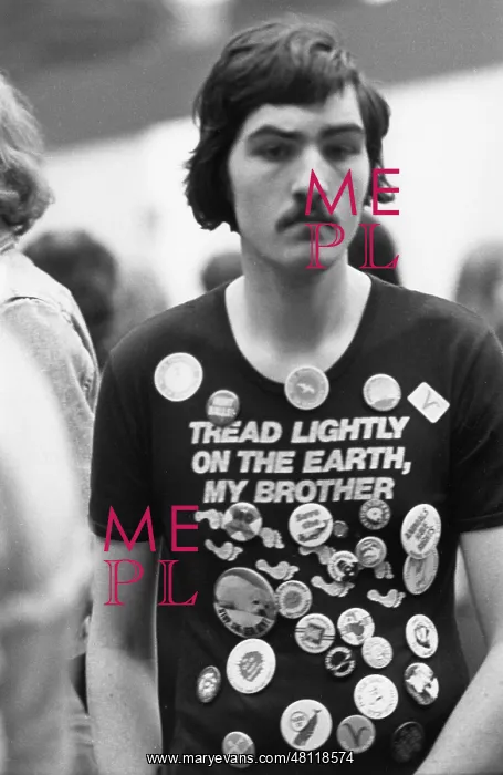 : Young man in teeshirt with slogan and badges : Young man in teeshirt with slogan and badges