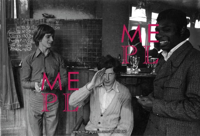 : Young men playing darts in a pub : Young men playing darts in a pub