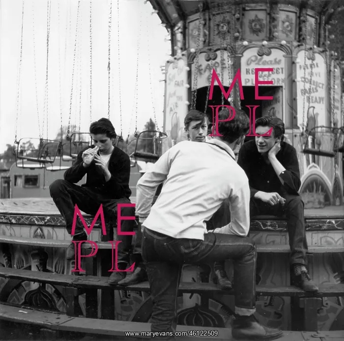 : Four young men on steps of fairground ride : Four young men on steps of fairground ride