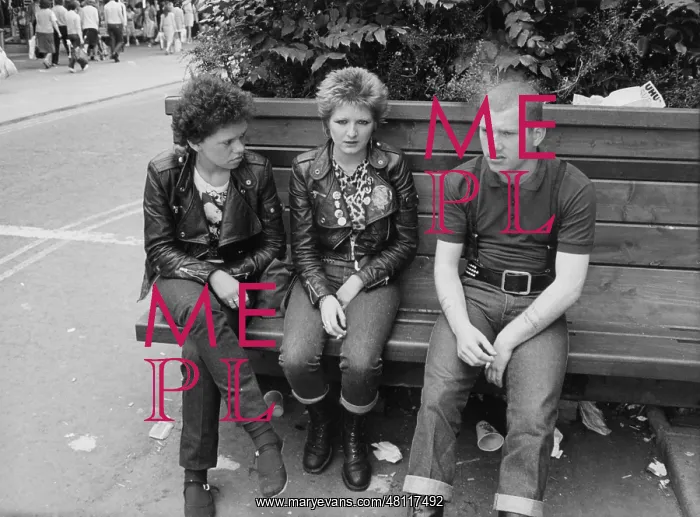 : Three young people sitting on a bench : Three young people sitting on a bench