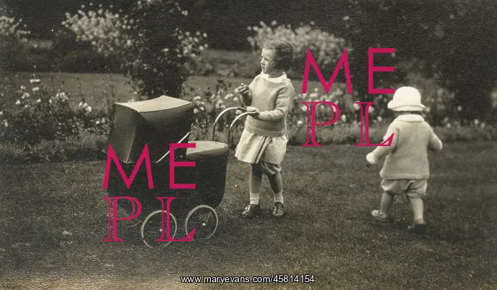: Two young siblings playing with a beautiful toy pram : Two young siblings playing with a beautiful toy pram