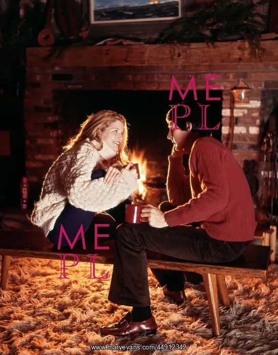 : Young Smiling Couple Sitting by Fireplace : Young Smiling Couple Sitting by Fireplace