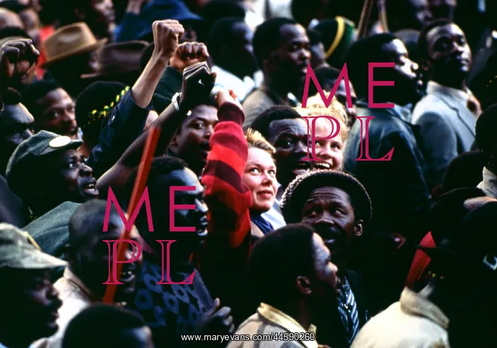 : Two young white students sit surrounded by a crowd : Two young white students sit surrounded by a crowd