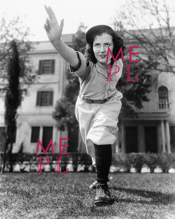 : Young woman in baseball uniform throwing a ball : Young woman in baseball uniform throwing a ball