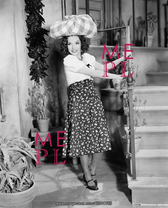 : Young woman carrying a bundle on her head and smiling : Young woman carrying a bundle on her head and smiling