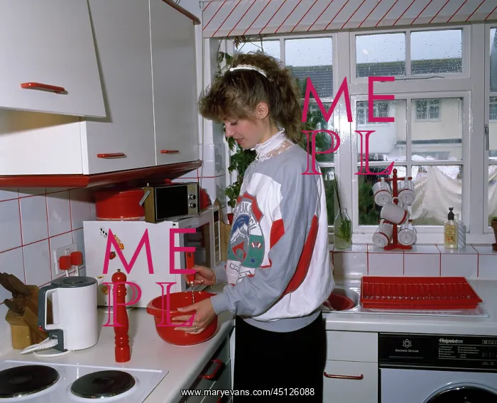  : Young woman cooking in a kitchen