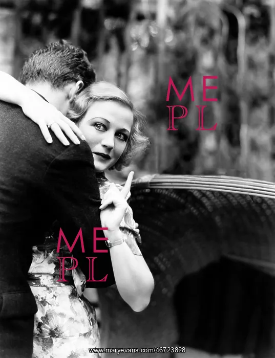 : Young woman embracing a man and pointing towards : Young woman embracing a man and pointing towards