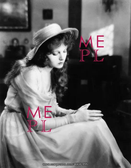 : Young woman in a hat sitting and looking sad : Young woman in a hat sitting and looking sad
